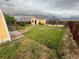 Lush backyard featuring a gazebo, stone pathway, and full wooden fence at 55619 E 31St Ave, Strasburg, CO 80136