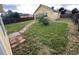 Spacious backyard with green grass, stone walkways, and a wooden fence at 55619 E 31St Ave, Strasburg, CO 80136