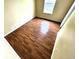 Bedroom featuring hardwood floors, a window for natural light, and fresh paint at 55619 E 31St Ave, Strasburg, CO 80136