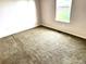 This cozy bedroom has neutral carpet, a window, and a spacious closet at 55619 E 31St Ave, Strasburg, CO 80136