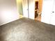 Cozy bedroom with neutral carpet and a door that leads to the Primary bathroom at 55619 E 31St Ave, Strasburg, CO 80136