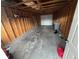 Interior view of unfinished garage with wood framing, concrete floor, and overhead door at 55619 E 31St Ave, Strasburg, CO 80136