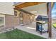 Backyard patio features a grill, covered space, and access to the well-maintained lawn and garden at 4381 S Estes St, Littleton, CO 80123
