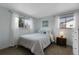 Inviting bedroom features soft lighting, serene decor, and large windows for ample natural light at 4381 S Estes St, Littleton, CO 80123