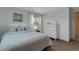 Comfortable bedroom features a large bed, a dresser, and a window, creating a cozy retreat at 4381 S Estes St, Littleton, CO 80123