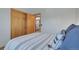 Bedroom featuring a comfortably made bed, closet, and window, with views of the outdoors at 4381 S Estes St, Littleton, CO 80123