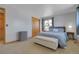 Relaxing bedroom featuring a comfortable bed, bench, and soft lighting, perfect for unwinding at 4381 S Estes St, Littleton, CO 80123