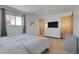 Bright bedroom features a bed, dresser, closet, and a window offering natural light and style at 4381 S Estes St, Littleton, CO 80123