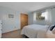 Sunlit bedroom with simple décor, a comfortable bed, closet and window with outdoor views at 4381 S Estes St, Littleton, CO 80123