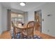 Cozy dining area with a wooden table, sliding glass doors, and view to the kitchen at 4381 S Estes St, Littleton, CO 80123
