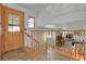 Bright foyer with a wooden door, tile floor, and railing, with an entrance view to the living area at 4381 S Estes St, Littleton, CO 80123