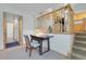 View of hallway and staircase with wooden banister leading to an upper level with a kitchen visible at 4381 S Estes St, Littleton, CO 80123