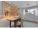 View of hallway area with a desk, chair, stairs and kitchen beyond with lots of natural light at 4381 S Estes St, Littleton, CO 80123