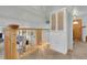 Upstairs hallway featuring wood railing and view into living room, with a built-in hutch at 4381 S Estes St, Littleton, CO 80123