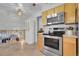 Modern stainless steel oven and microwave complement light wood cabinets and tile floors in this kitchen at 4381 S Estes St, Littleton, CO 80123