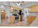 Featuring stainless steel appliances, the kitchen has ample cabinet space and tile floors that extend into the entryway at 4381 S Estes St, Littleton, CO 80123