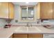 Bright kitchen with a double basin sink and window above, offering a functional and well-lit workspace at 4381 S Estes St, Littleton, CO 80123