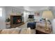 Cozy living room featuring a fireplace, comfortable seating, creating a welcoming atmosphere at 4381 S Estes St, Littleton, CO 80123