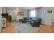 Inviting living room with hardwood floors, neutral decor, and staircase adding architectural interest at 4381 S Estes St, Littleton, CO 80123