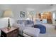 Inviting living room with a plush sofa, ottoman, side table, and view into the upper level kitchen area at 4381 S Estes St, Littleton, CO 80123