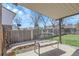 Outdoor patio featuring a bench with a floral cushion and a covered seating area, perfect for relaxation at 4381 S Estes St, Littleton, CO 80123