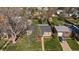 Birds eye view of the property showing manicured lawn, mature trees, detached garage, and neighborhood at 4530 S Pennsylvania St, Englewood, CO 80113