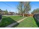 Spacious backyard with lush green grass, leading to a privacy fence and mature shade tree at 4530 S Pennsylvania St, Englewood, CO 80113
