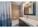Bathroom featuring tiled walls, a shower and bathtub, and a modern vanity with storage at 4530 S Pennsylvania St, Englewood, CO 80113