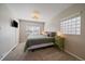 Comfortable bedroom features neutral colors, carpet, and a convenient mounted television at 4530 S Pennsylvania St, Englewood, CO 80113
