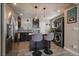 Chic kitchen boasts a breakfast bar with pendant lighting, stainless steel appliances, and convenient in-unit laundry at 4530 S Pennsylvania St, Englewood, CO 80113