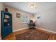 Office/bedroom space features hardwood floors, a desk, and a stylish blue bookshelf at 4530 S Pennsylvania St, Englewood, CO 80113