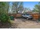 Gated parking area alongside a fenced yard with a vehicle ready for any adventure you want to take at 4530 S Pennsylvania St, Englewood, CO 80113