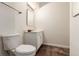 Cozy bathroom with a toilet, vanity, mirror, and modern lighting fixtures over the beautiful brown tile flooring at 12047 E Harvard Ave # 103, Aurora, CO 80014