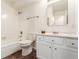Bathroom featuring a bathtub, toilet, mirror, and vanity, with tile flooring and well-lit space at 12047 E Harvard Ave # 103, Aurora, CO 80014