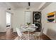 Cozy dining area with modern lighting and a convenient laundry setup at 12047 E Harvard Ave # 103, Aurora, CO 80014