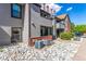 Exterior of home featuring muted siding, brick accents, and a stone garden at 12047 E Harvard Ave # 103, Aurora, CO 80014
