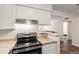 Well-lit kitchen with neutral countertops and modern appliances, open to the living area at 12047 E Harvard Ave # 103, Aurora, CO 80014
