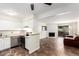 Kitchen open to the living room featuring stainless steel appliances and white cabinets at 12047 E Harvard Ave # 103, Aurora, CO 80014