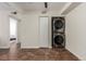 Practical laundry area featuring stacked washer and dryer units at 12047 E Harvard Ave # 103, Aurora, CO 80014