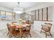 Cozy dining room with wooden table and chairs, open to a bright living space at 5819 W Milan Pl, Denver, CO 80235