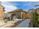 This backyard features a fenced-in yard with a patio area, complete with a table and chairs and a grill at 5926 S Jellison St # B, Littleton, CO 80123