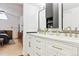 Bright bathroom features a double vanity with white cabinets, gold hardware, and black framed mirrors at 5926 S Jellison St # B, Littleton, CO 80123