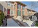 Charming exterior view with a brick facade, outdoor seating, and a well-manicured walkway to the front door at 5926 S Jellison St # B, Littleton, CO 80123