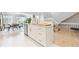 Modern kitchen with stainless steel appliances, a kitchen island, and views into the dining room at 5926 S Jellison St # B, Littleton, CO 80123