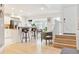This modern kitchen features a breakfast bar with seating, stainless steel appliances, and an open concept layout at 5926 S Jellison St # B, Littleton, CO 80123