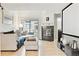 Cozy living room featuring a fireplace, light hardwood floors, and sliding glass doors to the backyard at 5926 S Jellison St # B, Littleton, CO 80123