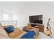 Comfortable living room with brown sectional, TV, guitar, and neutral walls at 5926 S Jellison St # B, Littleton, CO 80123