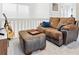 Comfortable living room with brown sectional, TV, guitar, and neutral walls at 5926 S Jellison St # B, Littleton, CO 80123