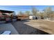 Backyard with a covered deck, gravel area, shed, and ample space for outdoor enjoyment at 7970 Wolff Ct, Westminster, CO 80030