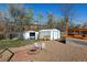 Backyard featuring storage sheds, patio, and a fire pit perfect for outdoor gatherings at 7970 Wolff Ct, Westminster, CO 80030